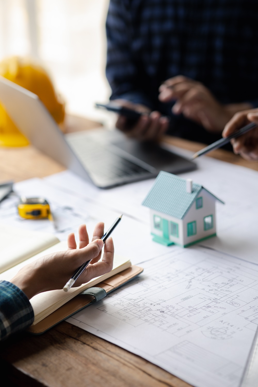 Group architects and engineers are in a meeting to discuss and inspect the house designs to meet the building and construction standards. Interior design and decoration ideas. Group architects and engineers are in a meeting to discuss and inspect the house designs to meet the building and construction standards. Interior design and decoration ideas.